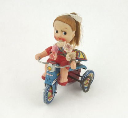 "Pony Tail Doll on Tricycle"