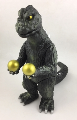 Godzilla Holding Two Gold Spheres