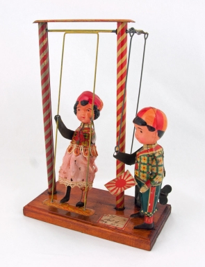 Girl on Swing with Boy Waving Japanese Flag
